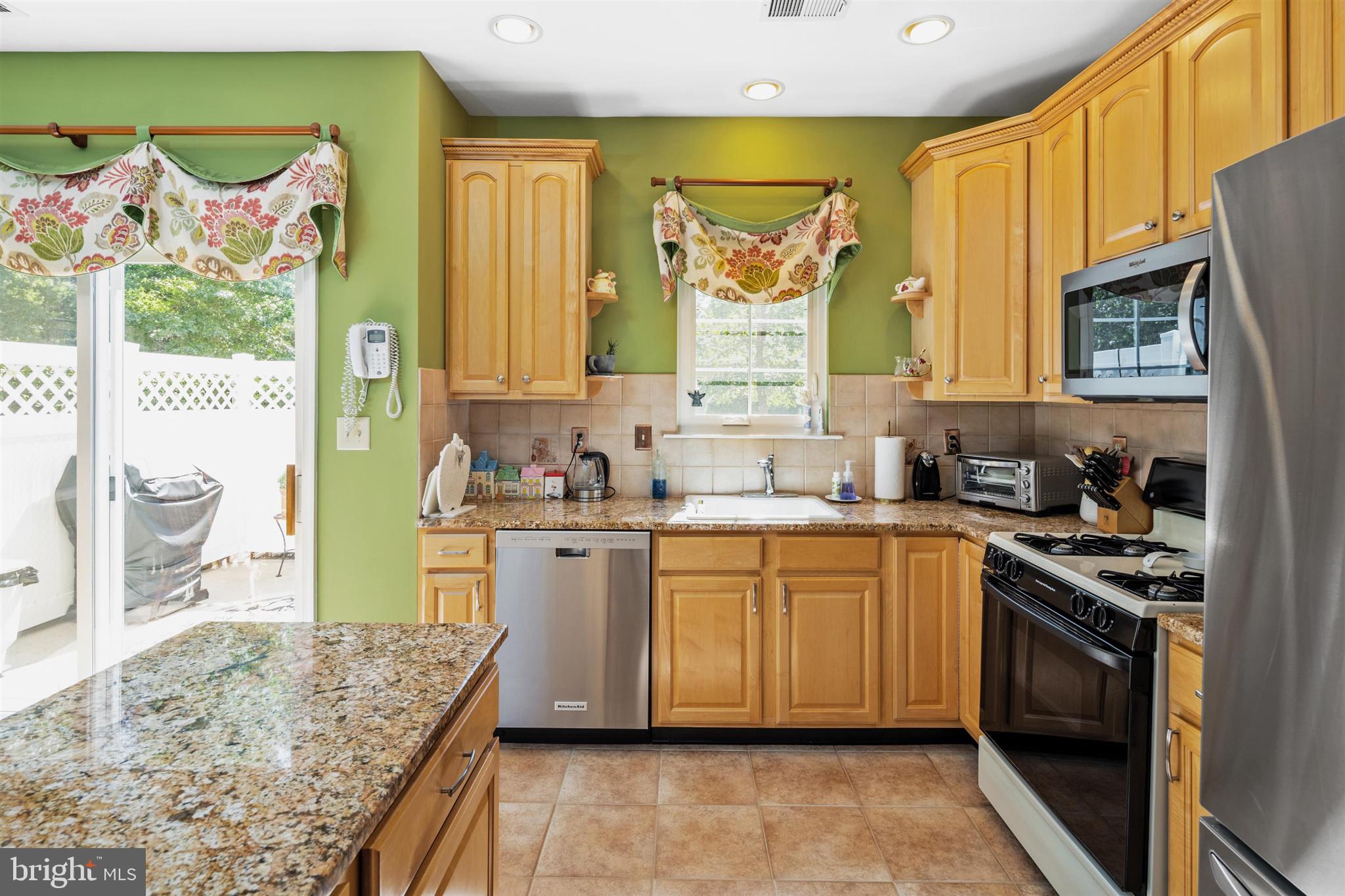 16 Winterberry Terrace Hamilton, NJ 08690 - Photo 10 of 26 a kitchen with stainless steel appliances granite countertop a stove a sink and a refrigerator