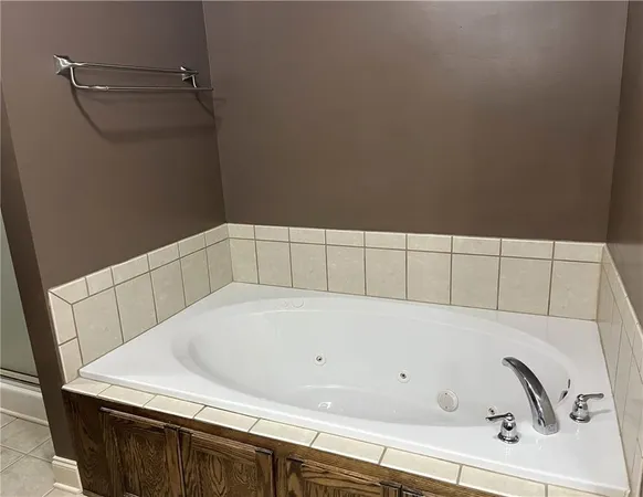 a bathroom with a glass shower door and mirror