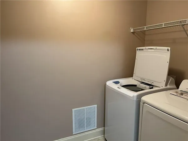 an empty room with wooden floor and closet area