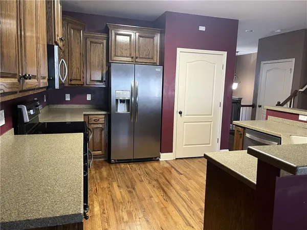 a kitchen with stainless steel appliances a refrigerator and a stove