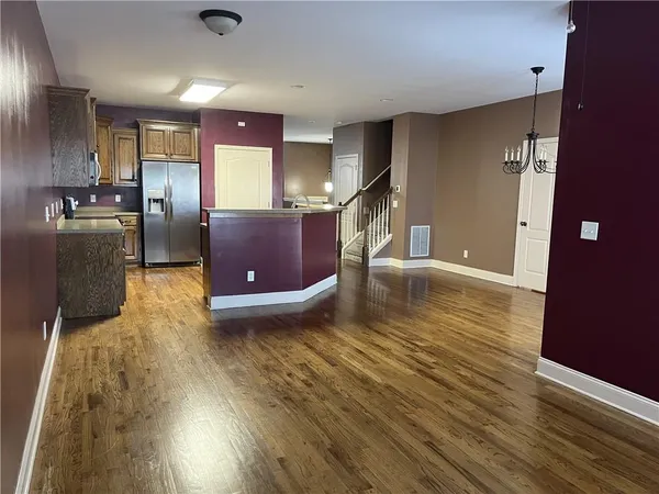 a view of a living room a wooden floor and a television