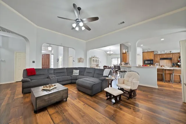 a living room with furniture and kitchen view