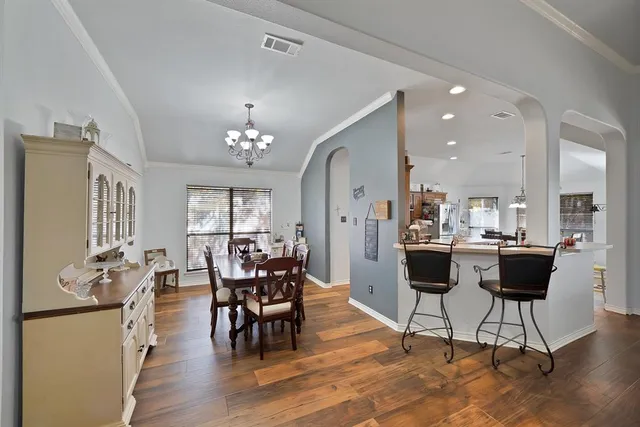 a view of a dining room with furniture and wooden floor