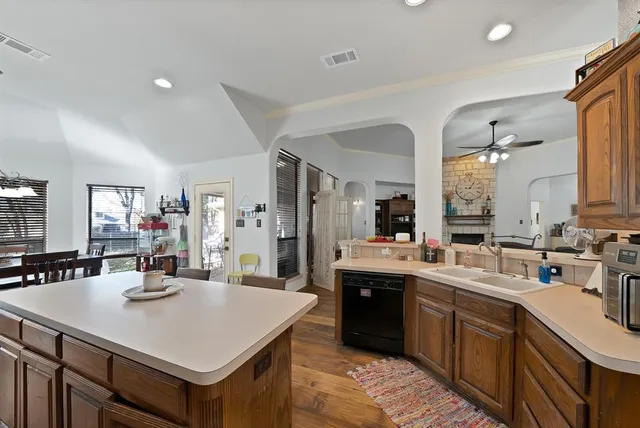 a kitchen with a sink a stove and chairs