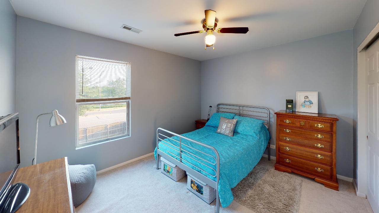 468 Butterfly Road Bolingbrook, IL 60490 - Photo 23 of 35 a bedroom with a bed and a chandelier