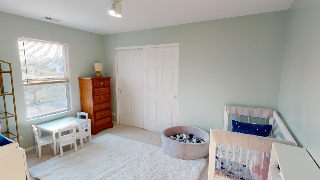 468 Butterfly Road Bolingbrook, IL 60490 - Photo 26 of 35 a bedroom with furniture and a window