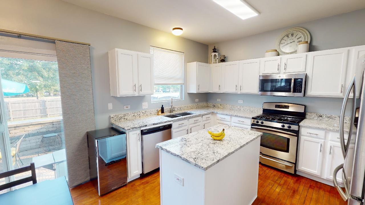 468 Butterfly Road Bolingbrook, IL 60490 - Photo 9 of 35 a kitchen with stainless steel appliances granite countertop a stove a sink and a refrigerator