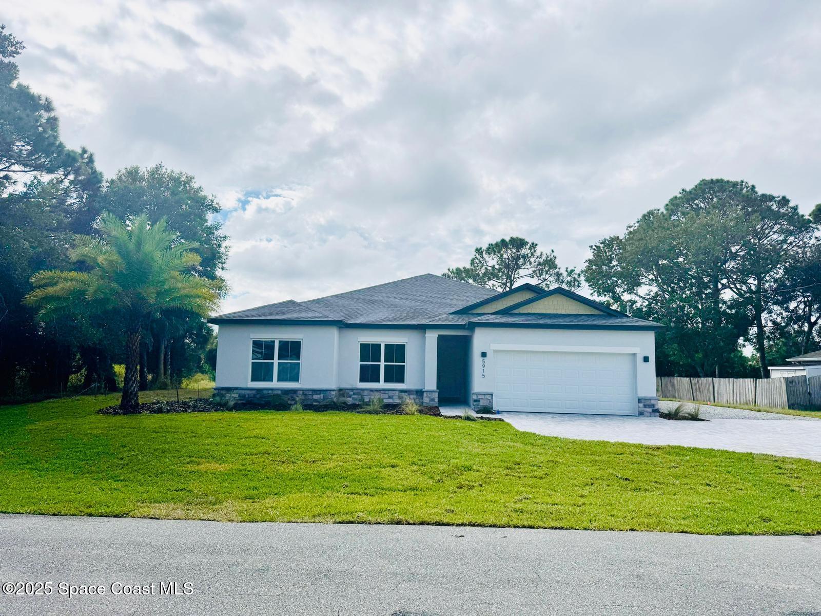 5915 Akers Street Cocoa, FL 32927 - Photo 2 of 33 a front view of house with yard and green space