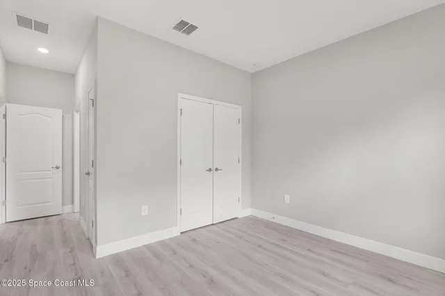 a view of an empty room and wooden floor