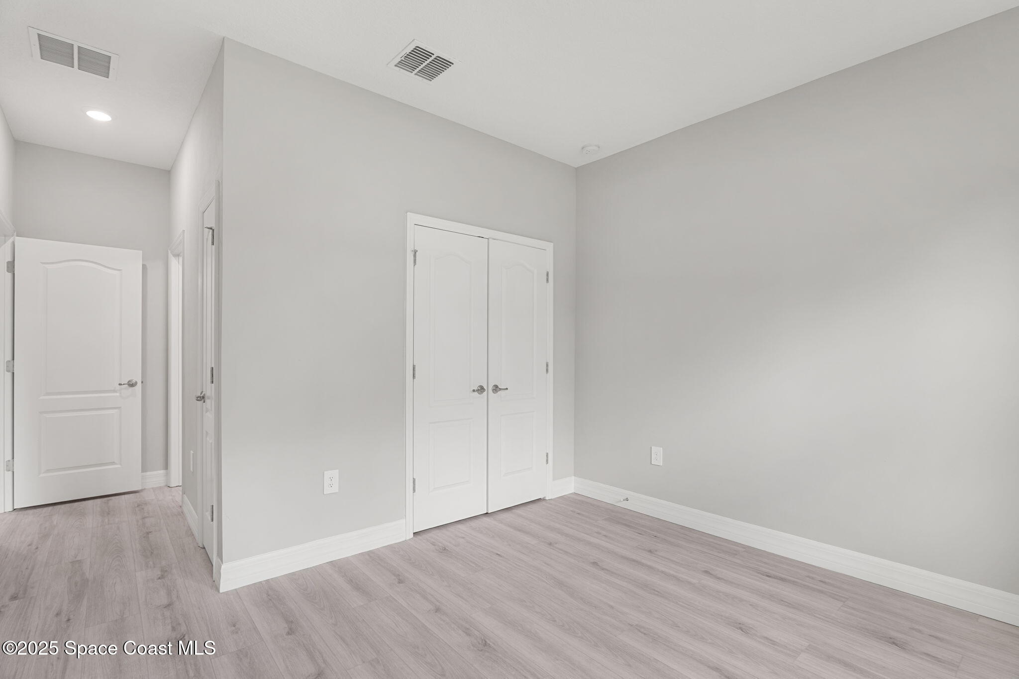5915 Akers Street Cocoa, FL 32927 - Photo 21 of 33 a view of an empty room and wooden floor