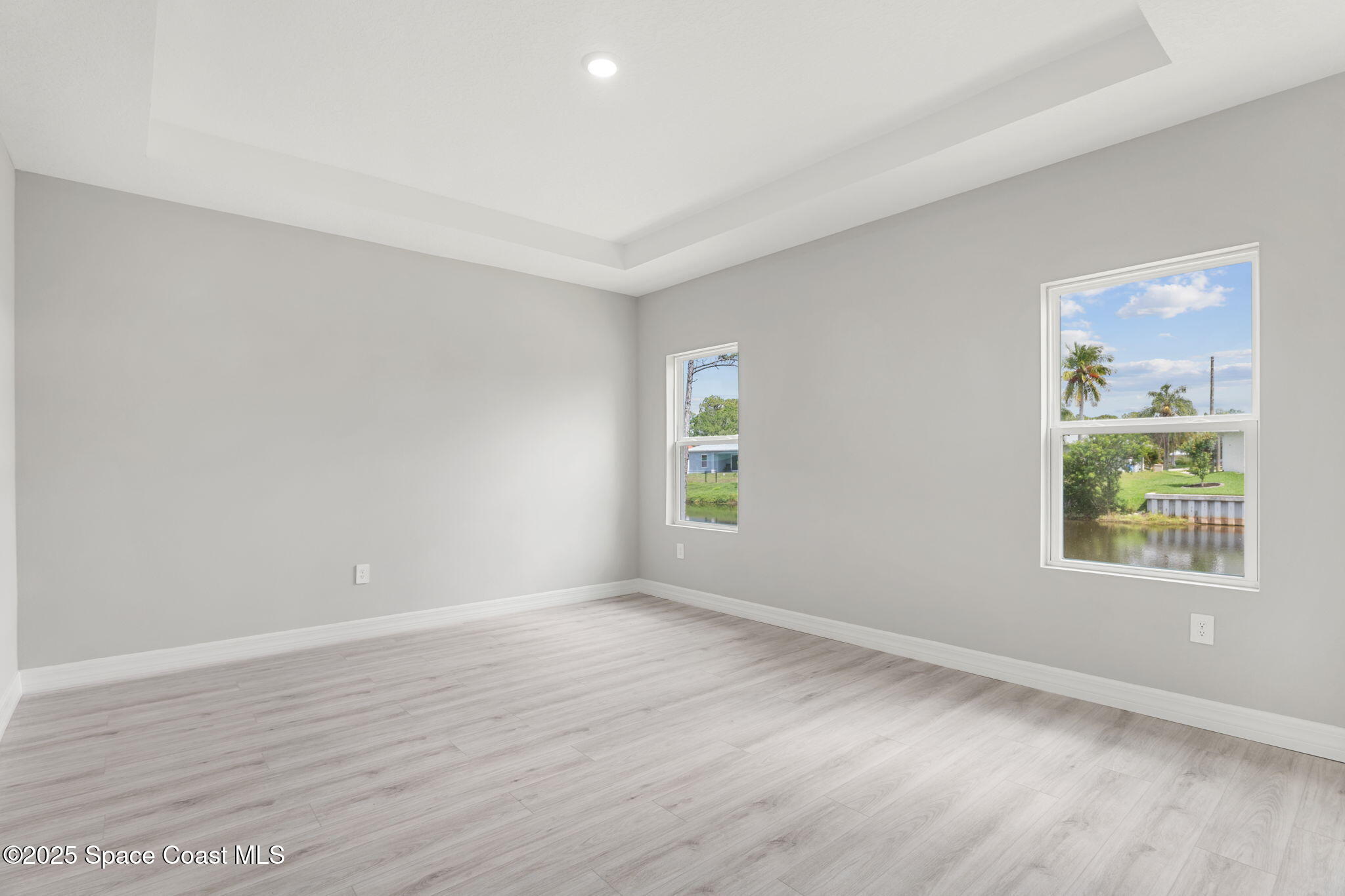 5915 Akers Street Cocoa, FL 32927 - Photo 25 of 33 an empty room with wooden floor and windows