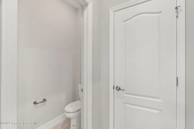 a bathroom with a granite countertop toilet and a sink