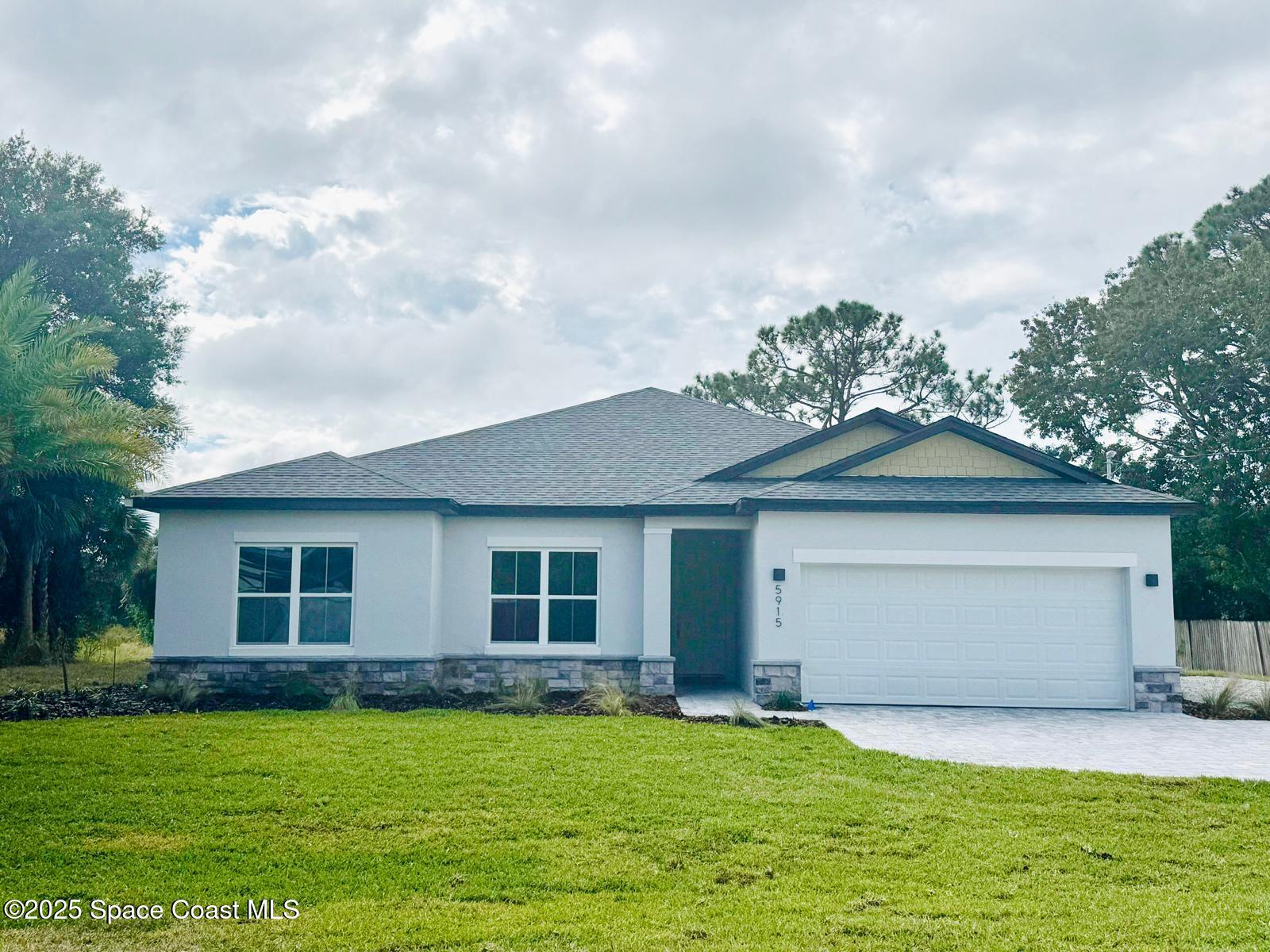 5915 Akers Street Cocoa, FL 32927 - Photo 4 of 33 a front view of a house with a garden and yard