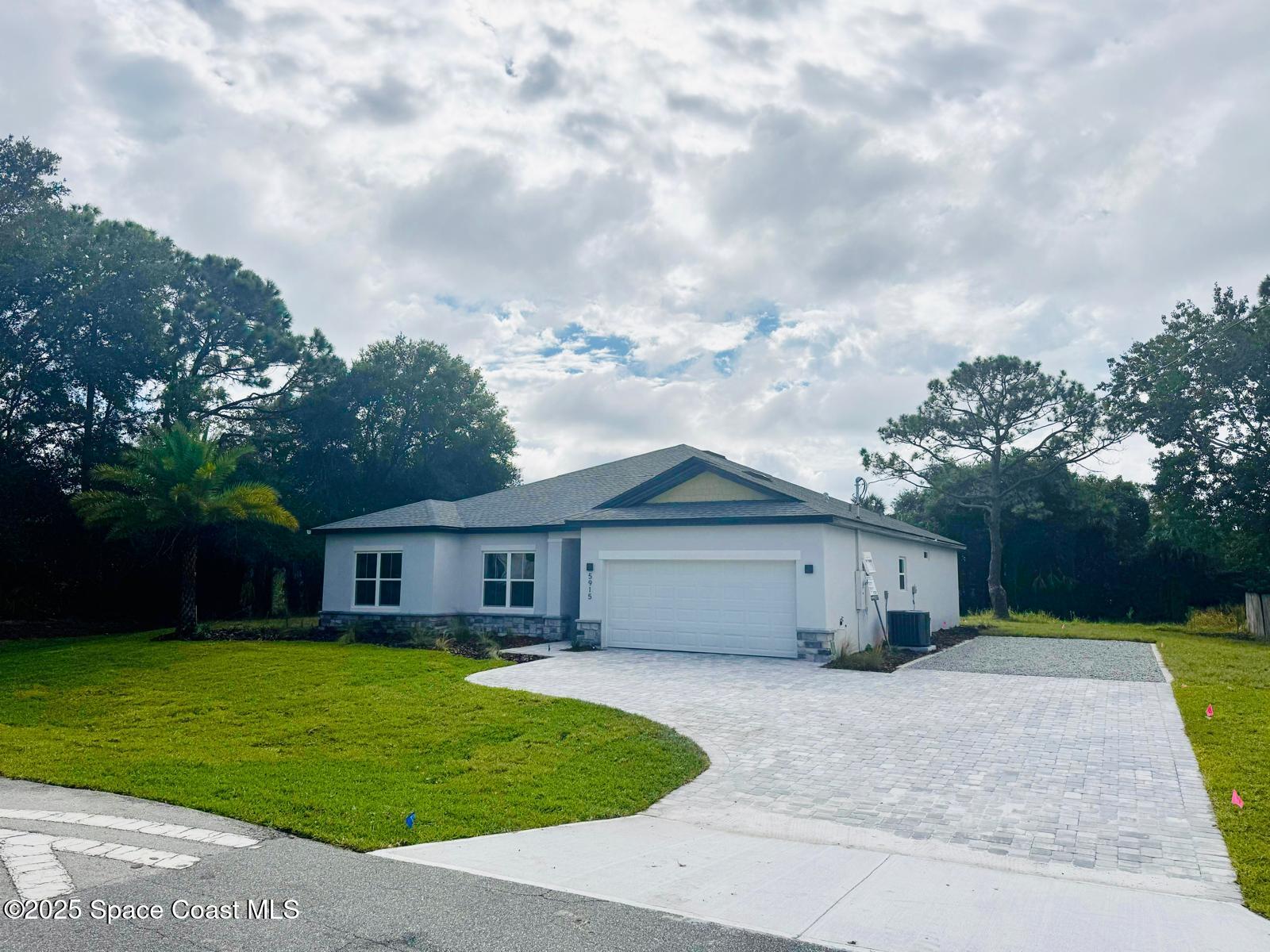 5915 Akers Street Cocoa, FL 32927 - Photo 6 of 33 a front view of a house with garden