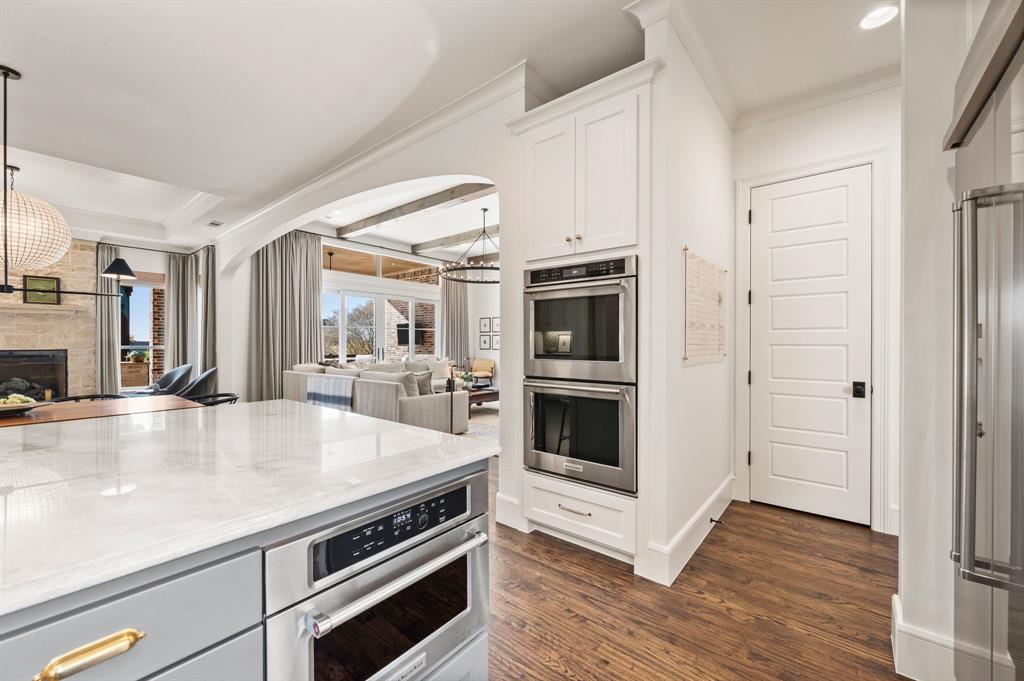 909 Winding Ridge Trail Southlake, TX 76092 - Photo 15 of 36 a kitchen with stainless steel appliances a white stove cabinets and wooden floor