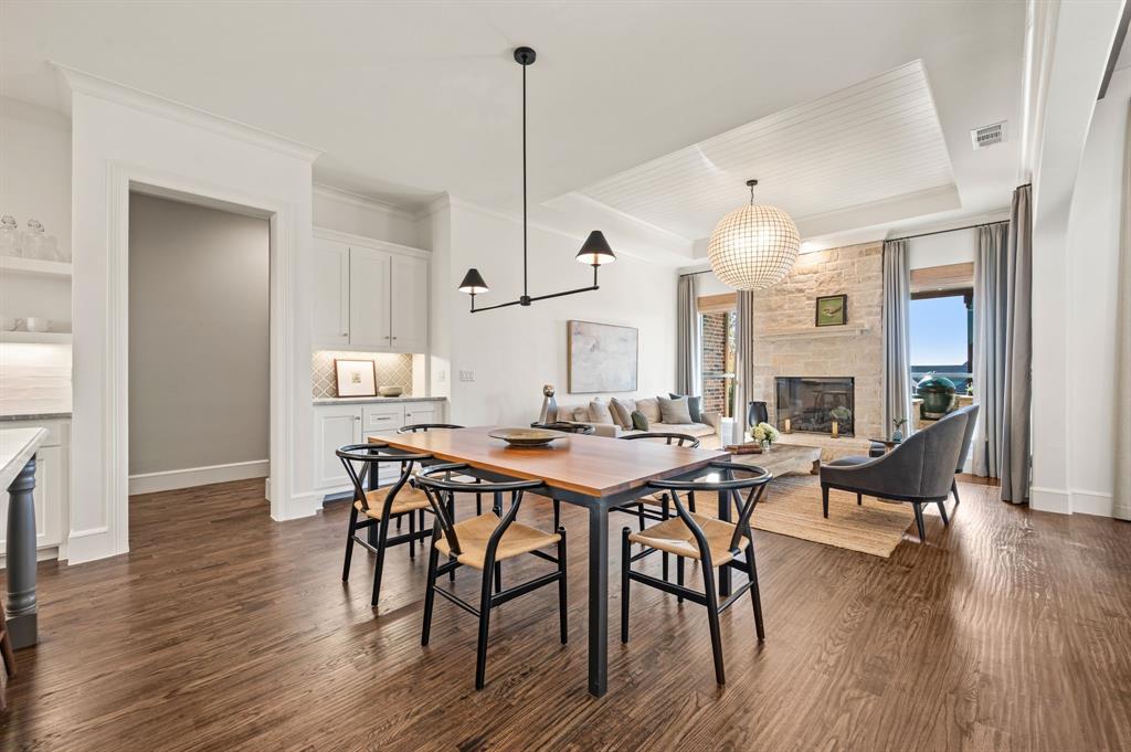 909 Winding Ridge Trail Southlake, TX 76092 - Photo 16 of 36 a view of a a dining room and livingroom with furniture wooden floor a rug a painting and a chandelier