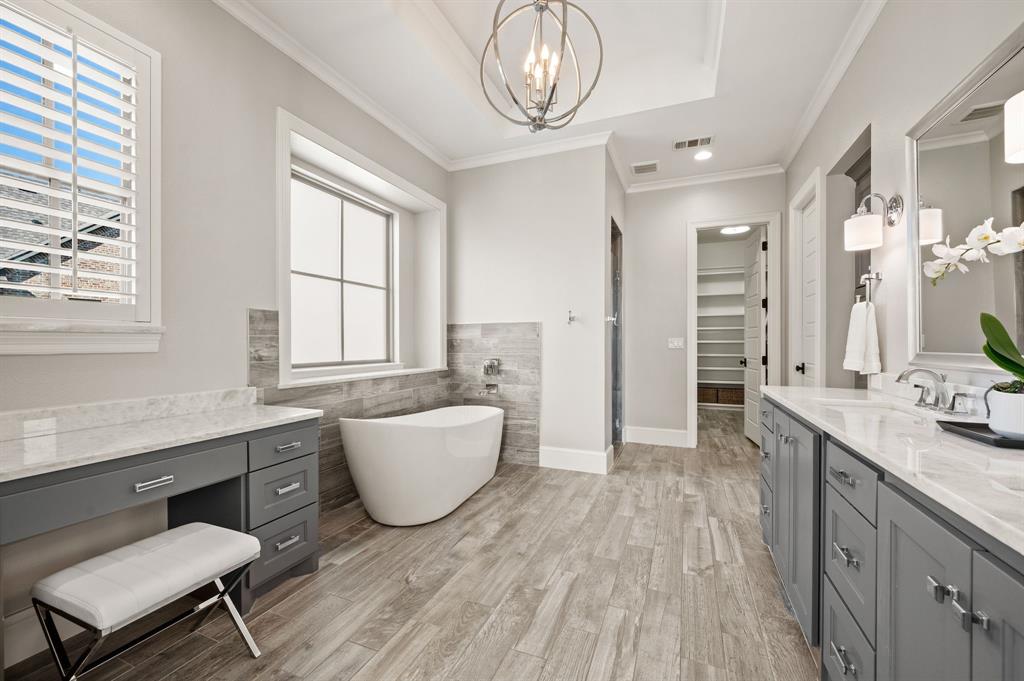 909 Winding Ridge Trail Southlake, TX 76092 - Photo 20 of 36 a spacious bathroom with a granite countertop sink a mirror and a bathtub