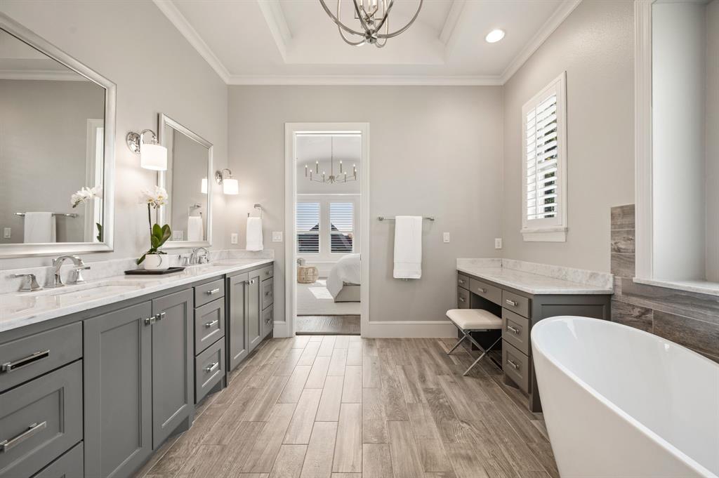 909 Winding Ridge Trail Southlake, TX 76092 - Photo 21 of 36 a spacious bathroom with a double vanity sink a mirror and a bathtub