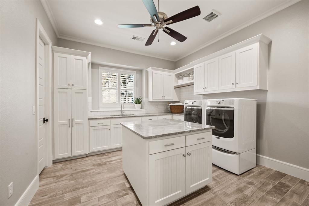 909 Winding Ridge Trail Southlake, TX 76092 - Photo 25 of 36 a kitchen with stainless steel appliances granite countertop a stove a sink and a refrigerator with white cabinets