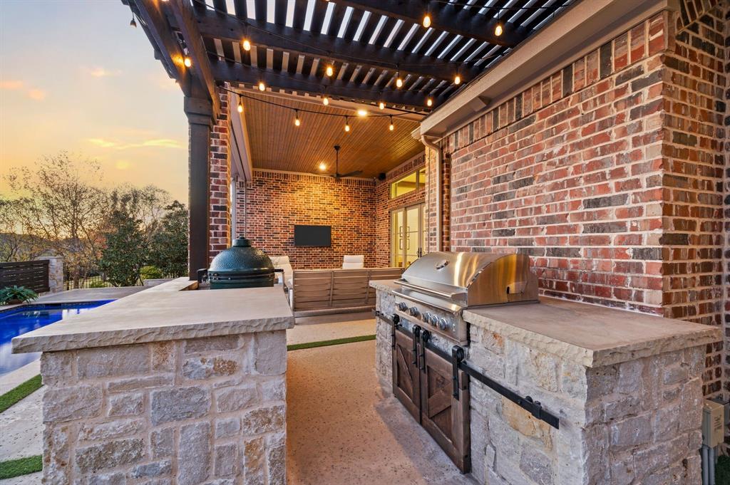 909 Winding Ridge Trail Southlake, TX 76092 - Photo 29 of 36 a view of a kitchen with kitchen island a stove a sink dishwasher and wooden cabinets with potted plants