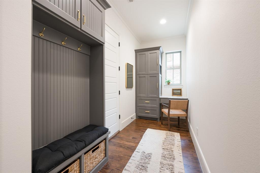 909 Winding Ridge Trail Southlake, TX 76092 - Photo 7 of 36 a hallway with a wooden floor and a bathroom