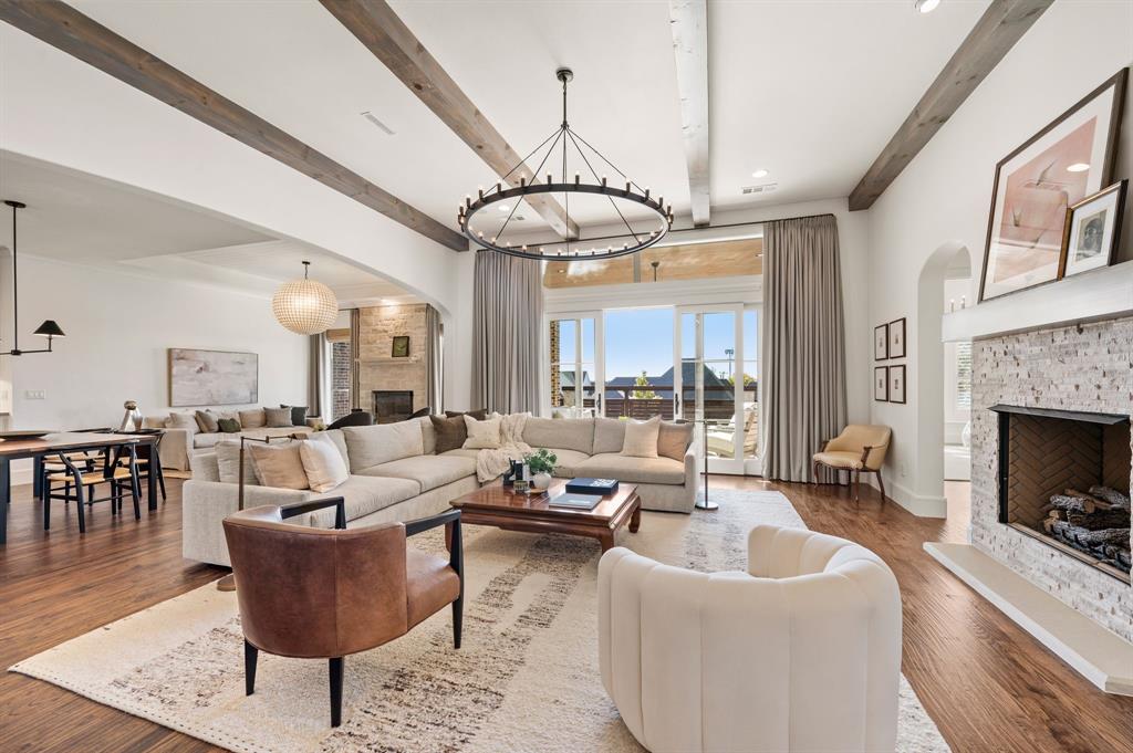 909 Winding Ridge Trail Southlake, TX 76092 - Photo 10 of 36 a living room with furniture a chandelier and a fireplace