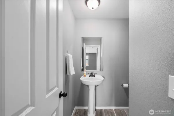 a living room with furniture a table and kitchen view