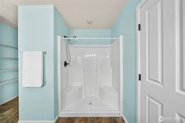 a view of a room with wooden floor white walls and entryway