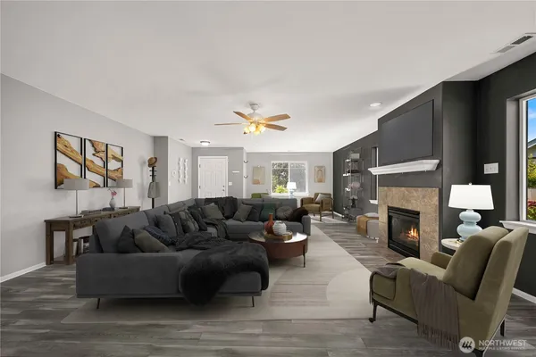 a living room with furniture a fireplace and a flat screen tv