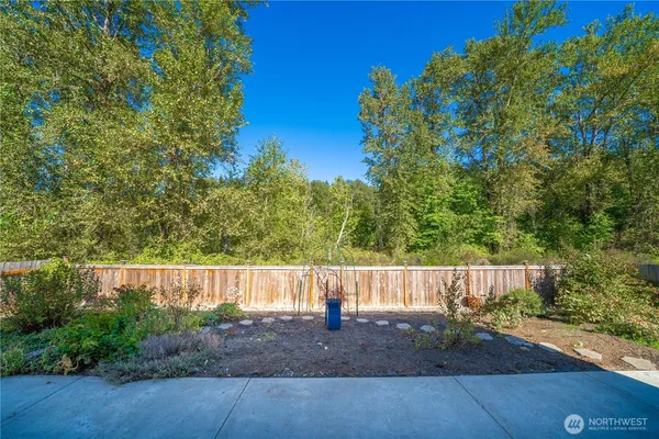 a view of a house with wooden fence