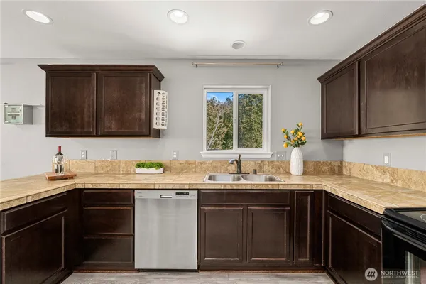a kitchen with a sink stove and microwave