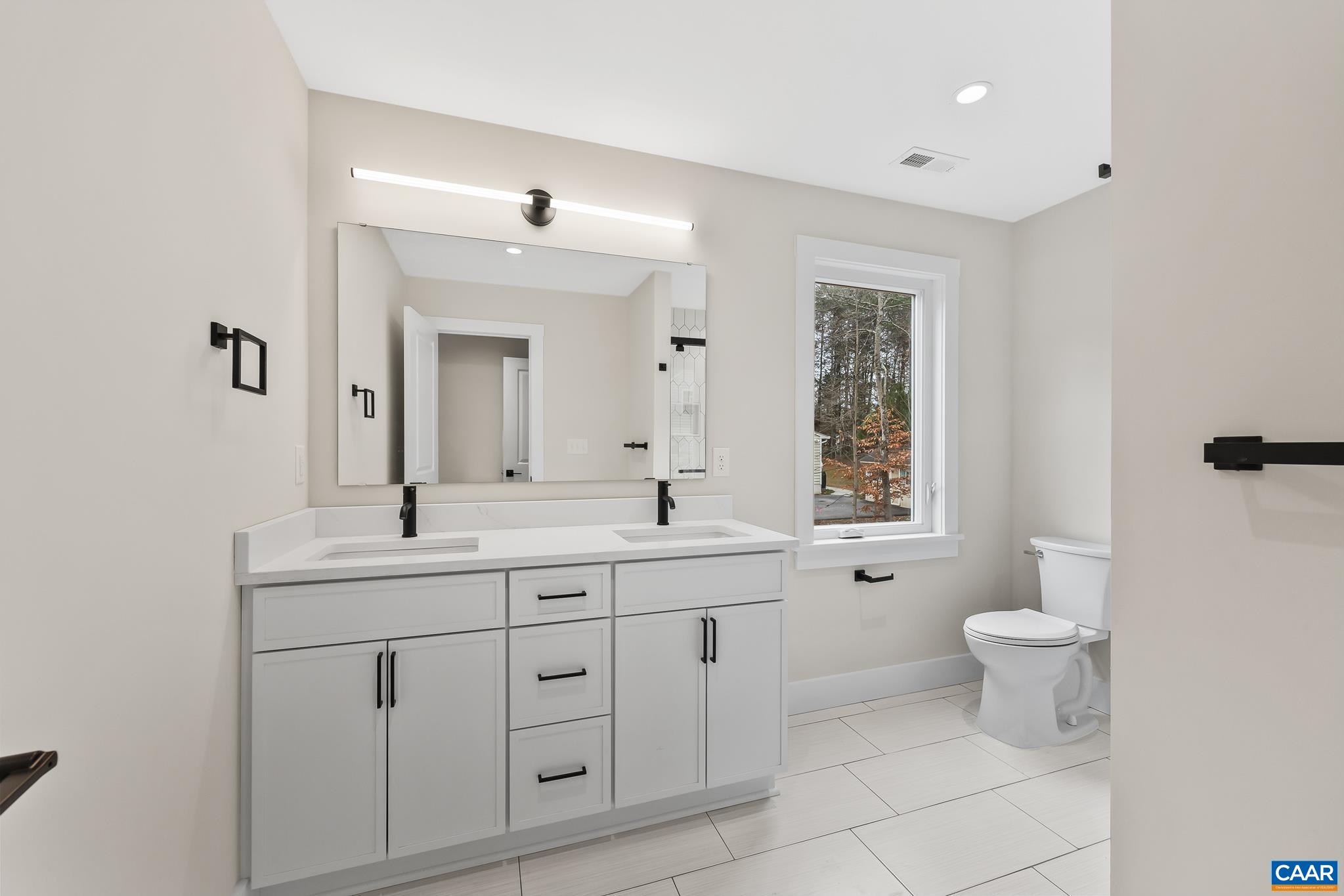 34 Turkeysag Trail Palmyra, VA 22963 - Photo 27 of 55 a bathroom with a double vanity sink a toilet and a mirror
