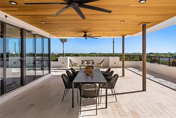 a view of a terrace with furniture and a city view