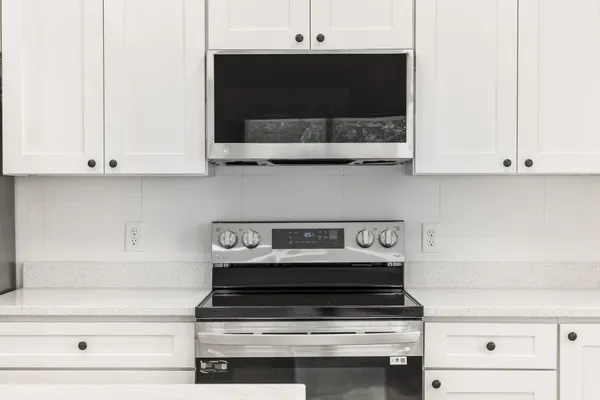 a stove top oven sitting inside of a kitchen