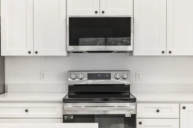 a stove top oven sitting inside of a kitchen