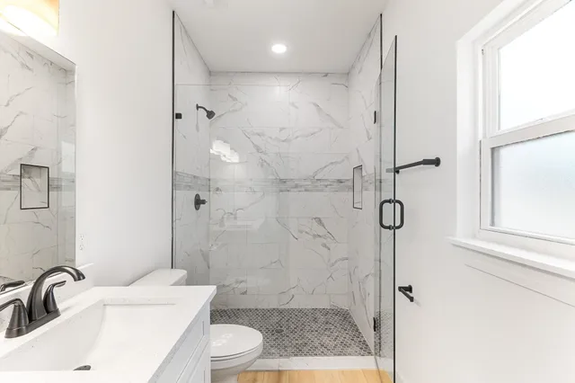 a bathroom with a sink toilet and shower