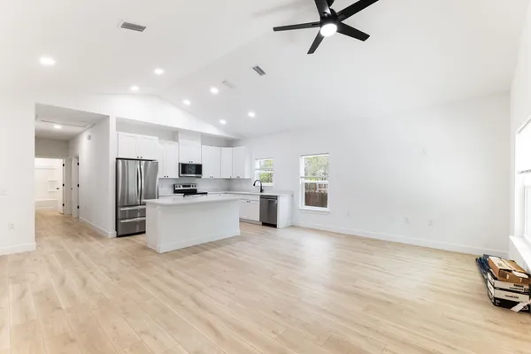 a view of kitchen with stainless steel appliances refrigerator oven and stove
