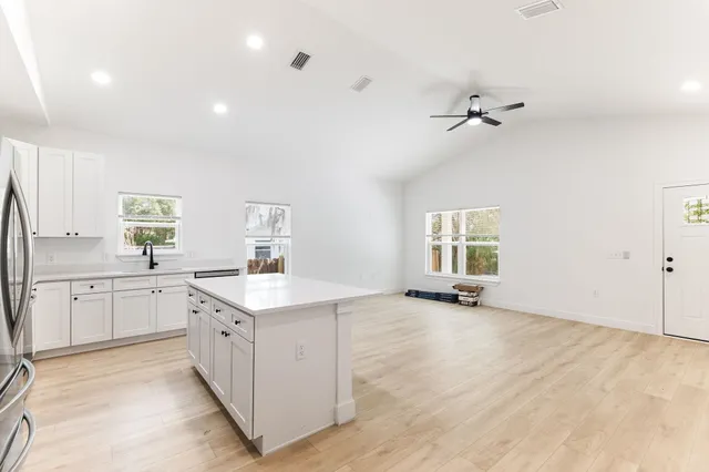 a view of a kitchen with a sink hardwood floor and a window