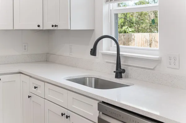 a kitchen with a sink and cabinets