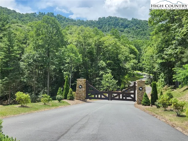 a couple of cars parked in front of a house