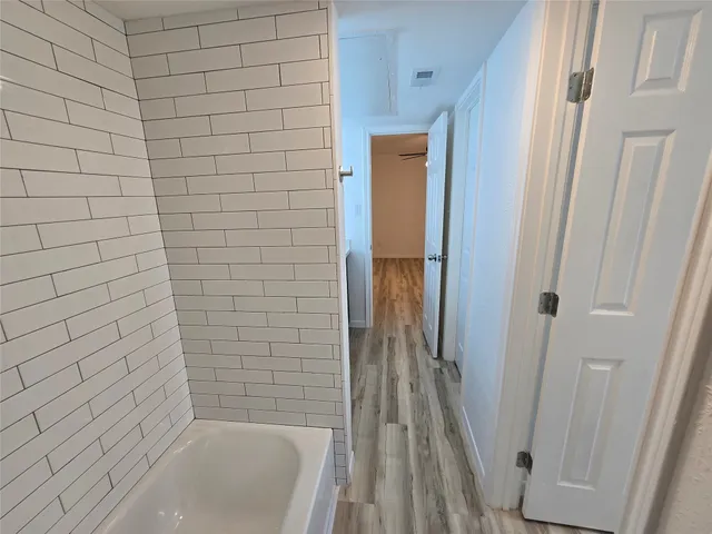 a bathroom with a granite countertop sink a mirror and shower
