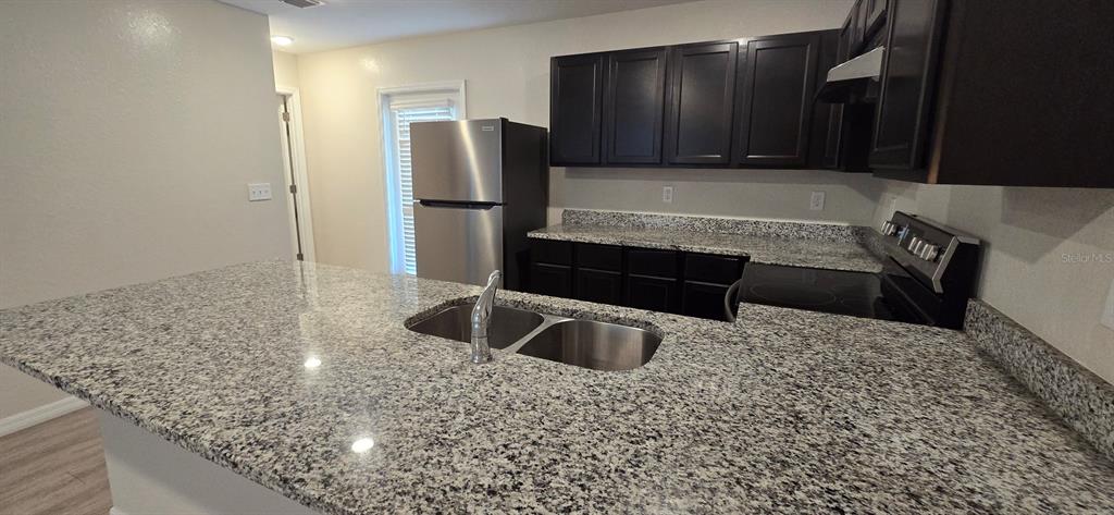 44 Walnut Road, Unit 4 Ocala, FL 34480 - Photo 3 of 7 a kitchen with a refrigerator and a sink