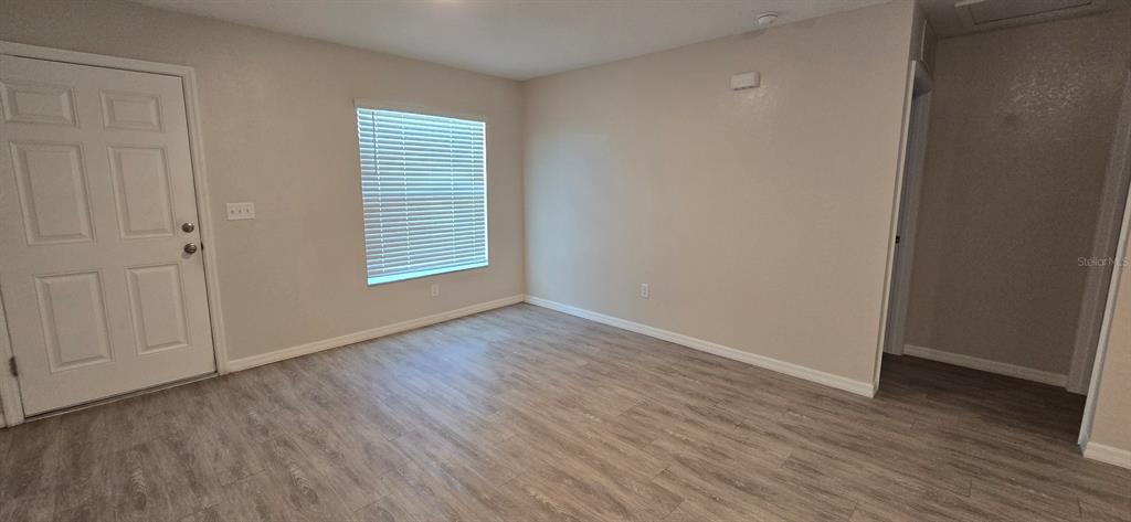 44 Walnut Road, Unit 4 Ocala, FL 34480 - Photo 4 of 7 a view of an empty room with wooden floor and a window