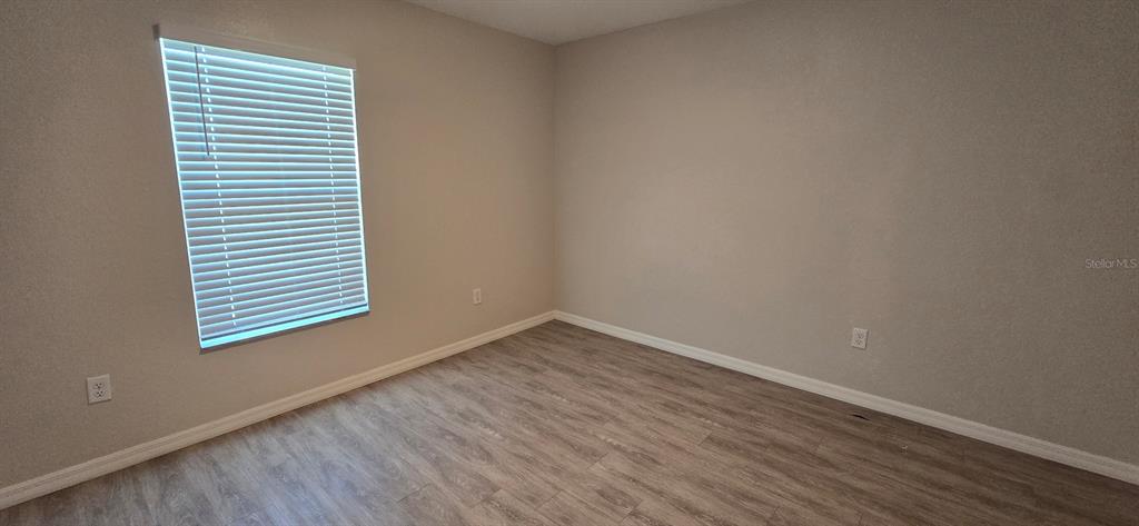 44 Walnut Road, Unit 4 Ocala, FL 34480 - Photo 6 of 7 a view of an empty room with wooden floor and a window