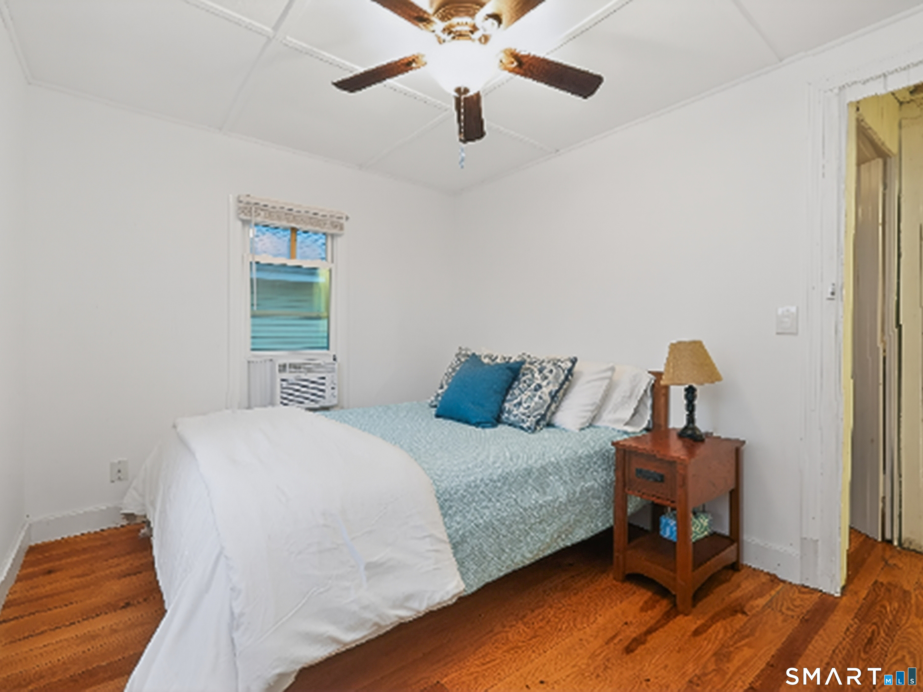 31 Old Colony Road Old Lyme, CT 06371 - Photo 26 of 38 a bedroom with a bed and wooden floor
