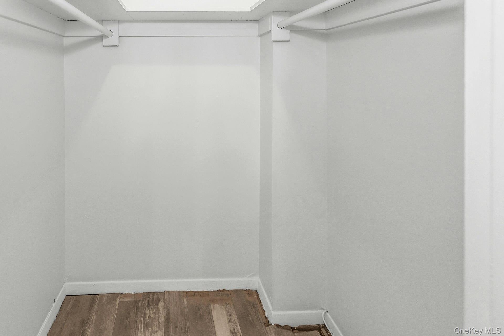 75 Noble Street, Unit 121 Lynbrook, NY 11563 - Photo 12 of 24 a view of walk in closet with empty racks