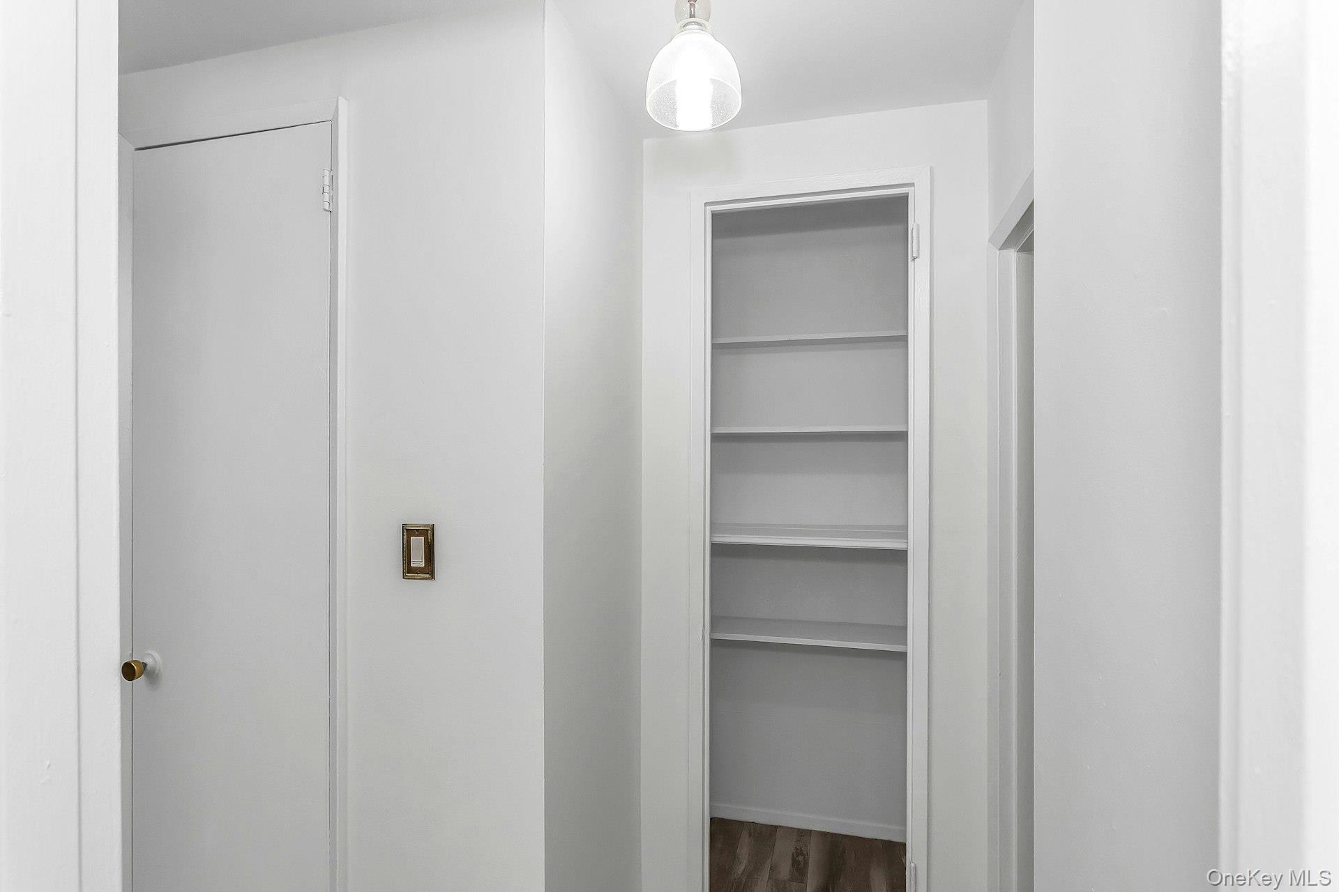 75 Noble Street, Unit 121 Lynbrook, NY 11563 - Photo 15 of 24 a view of a room with rack on the wall