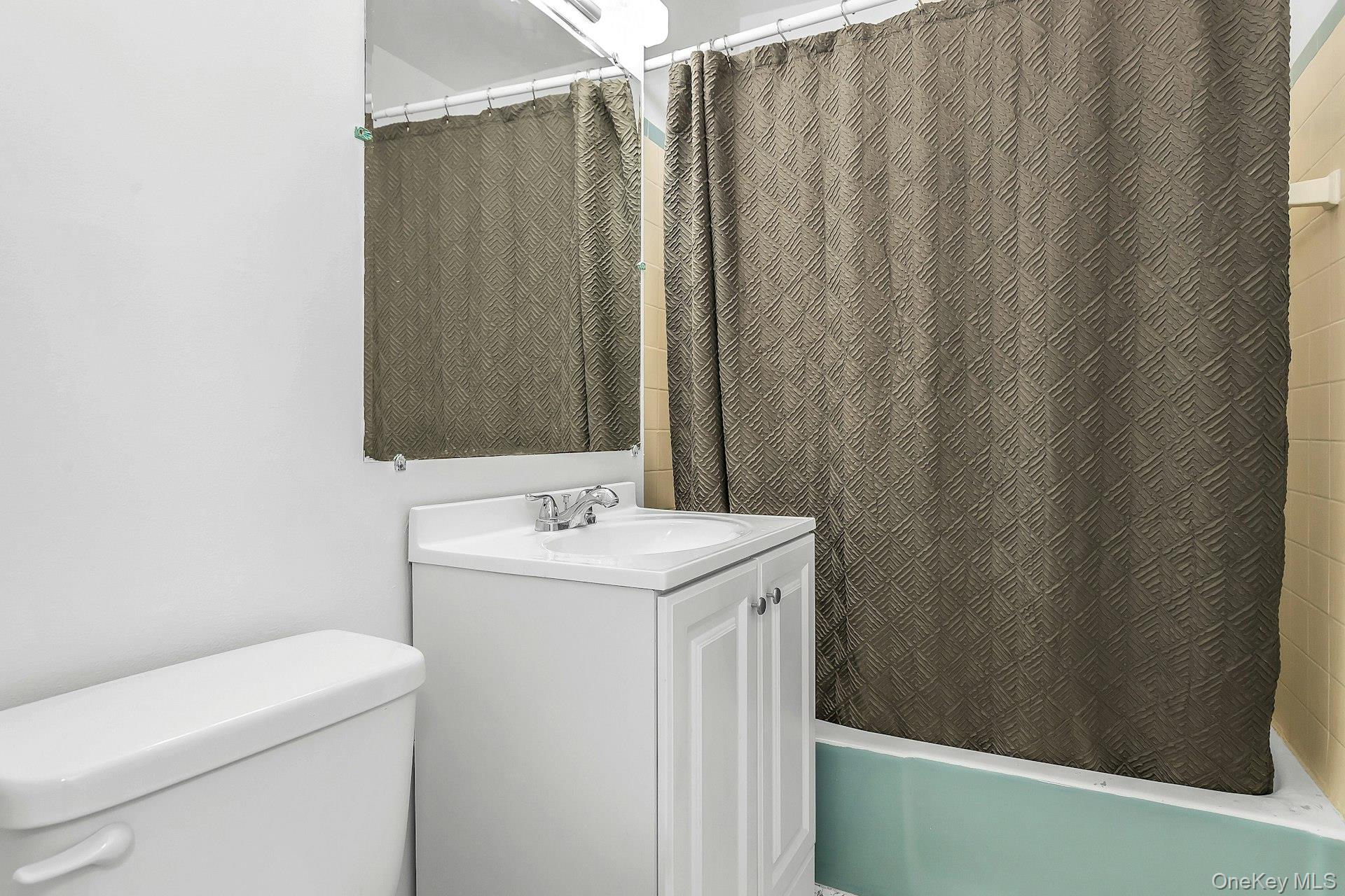 75 Noble Street, Unit 121 Lynbrook, NY 11563 - Photo 16 of 24 a bathroom with a sink toilet and vanity