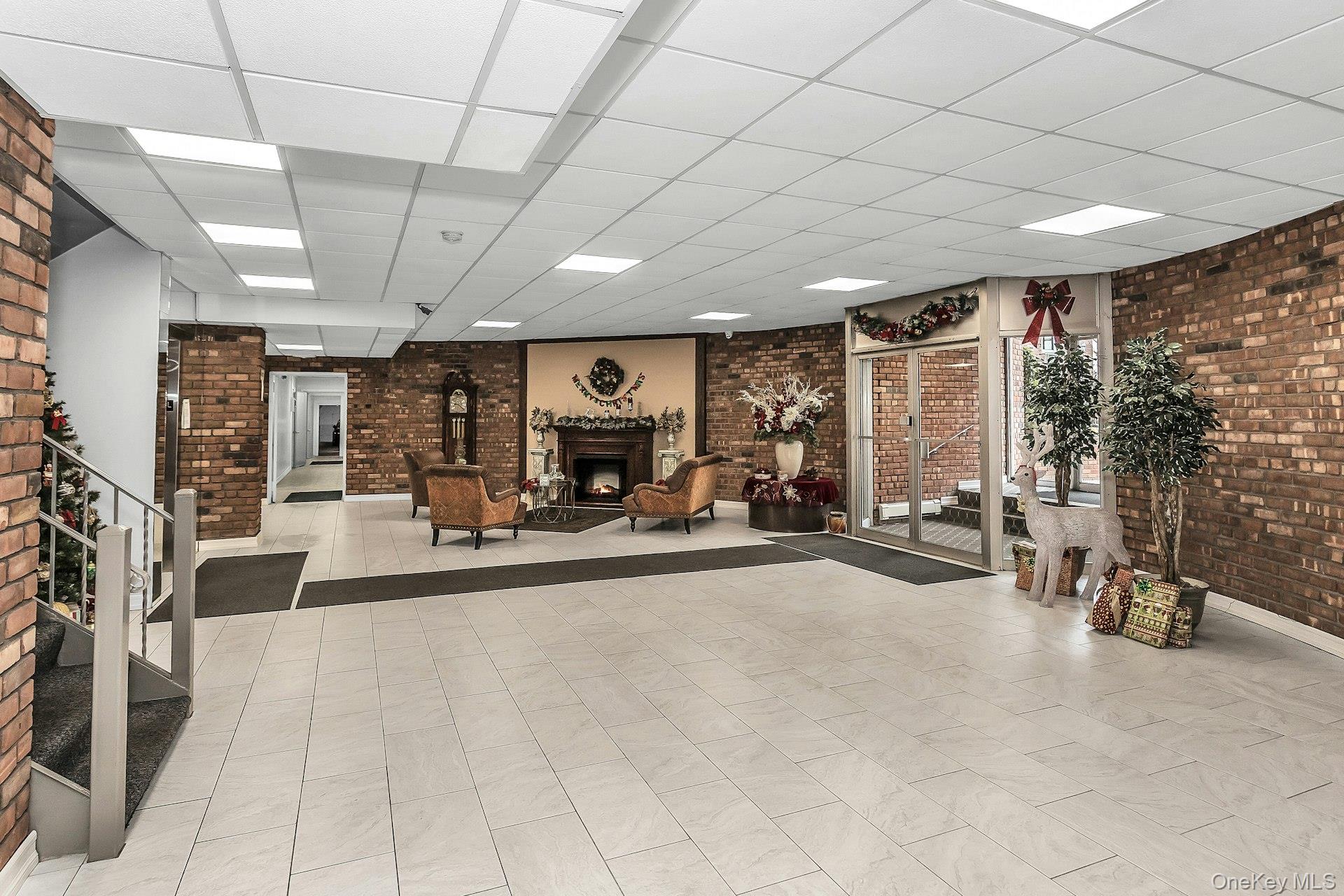 75 Noble Street, Unit 121 Lynbrook, NY 11563 - Photo 17 of 24 a view of a hall with gym equipment