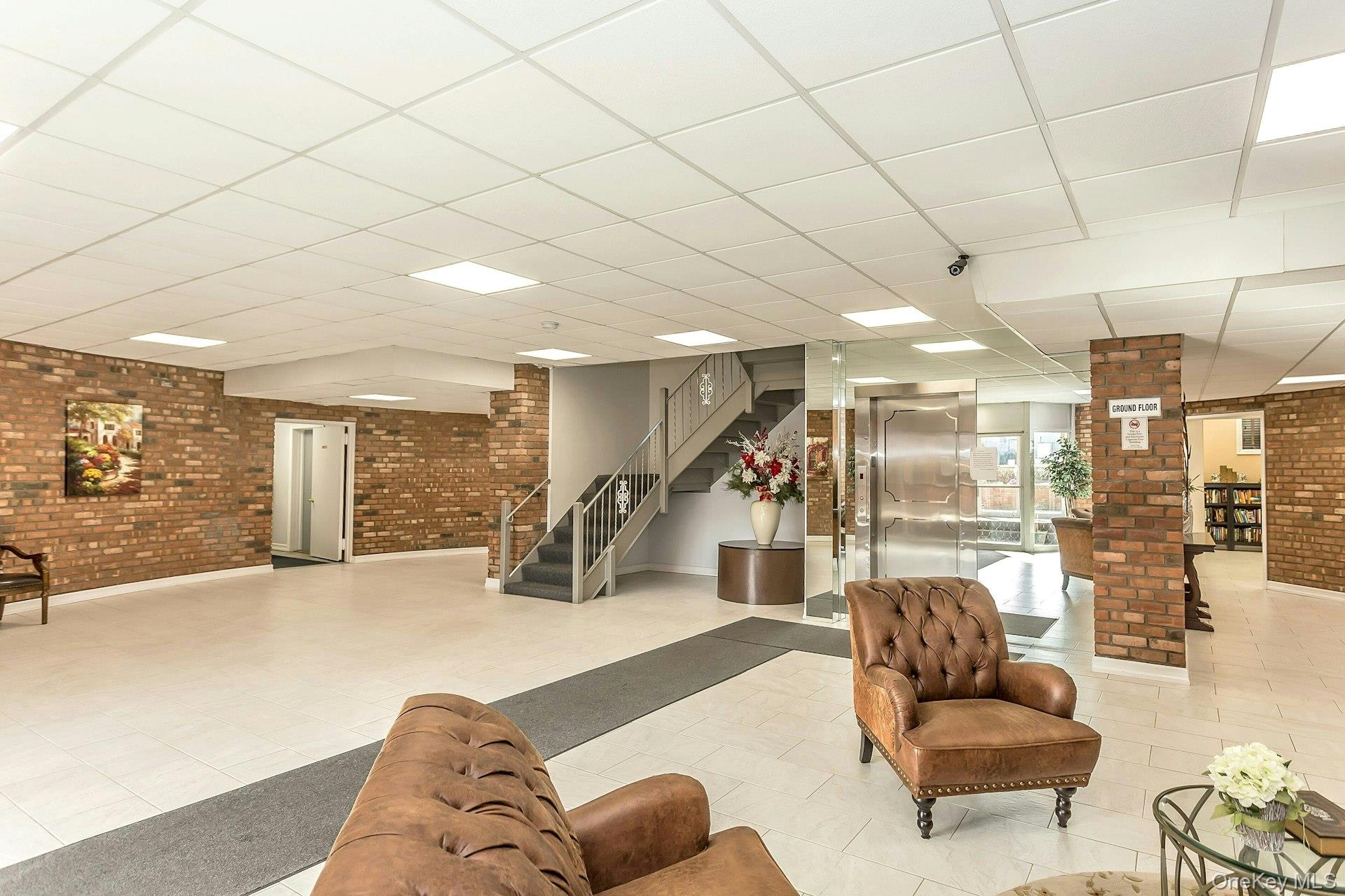 75 Noble Street, Unit 121 Lynbrook, NY 11563 - Photo 19 of 24 a living room with furniture and a large window
